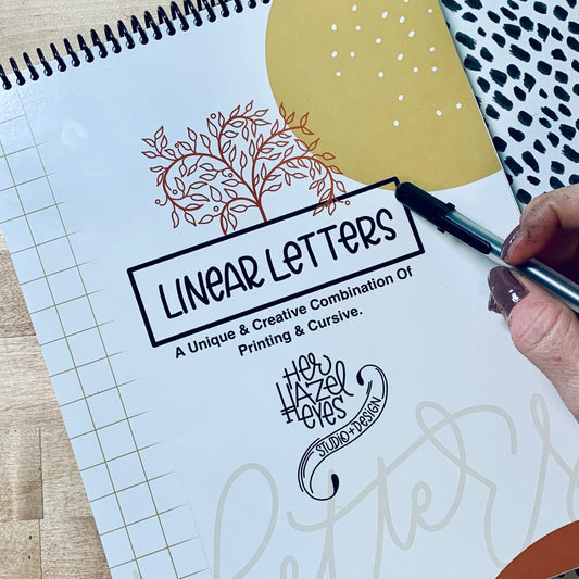 Hand lettering workbook showing traceable linear letter styles