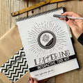 Top spiral binding for easy use by right or left-handed letterers