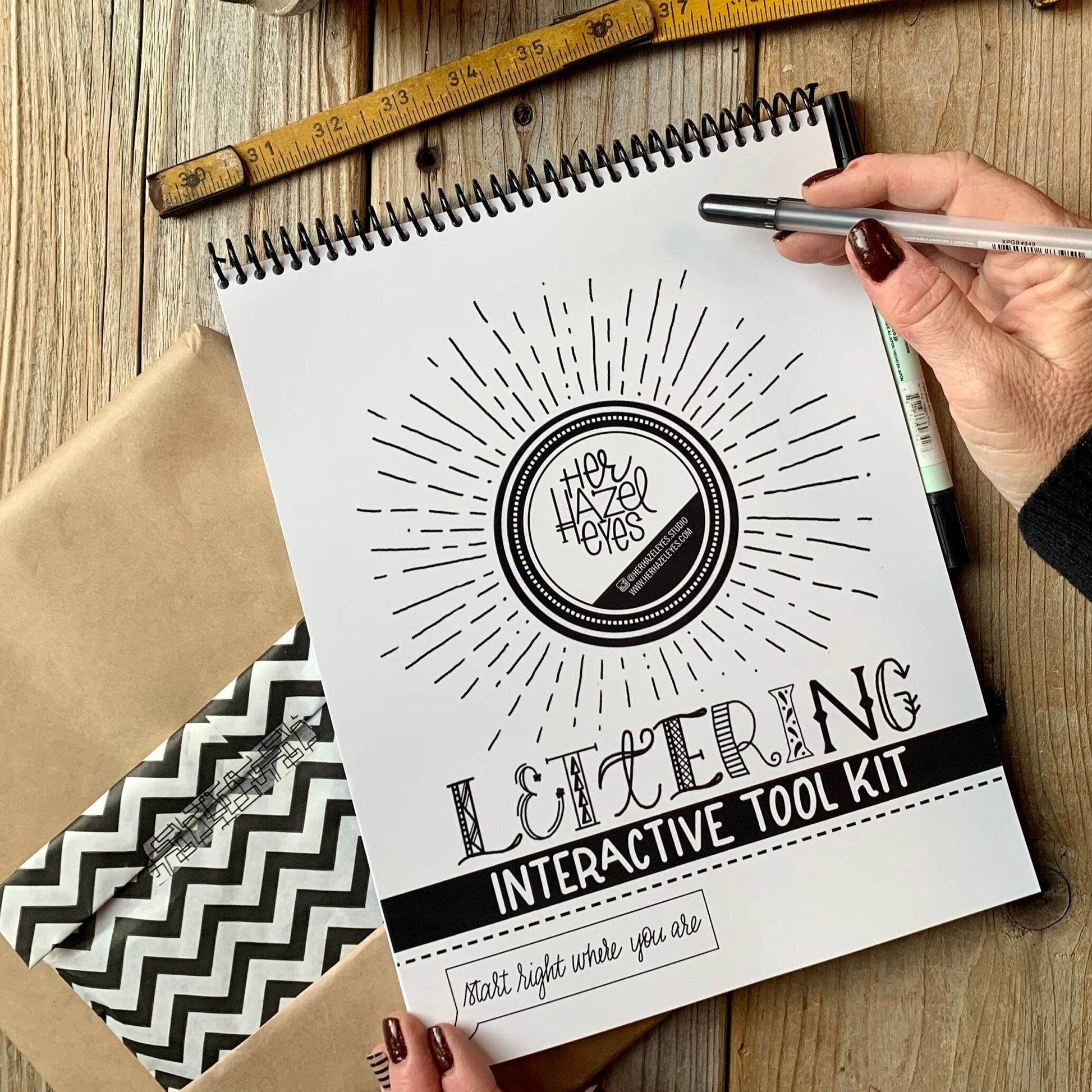 Top spiral binding for easy use by right or left-handed letterers
