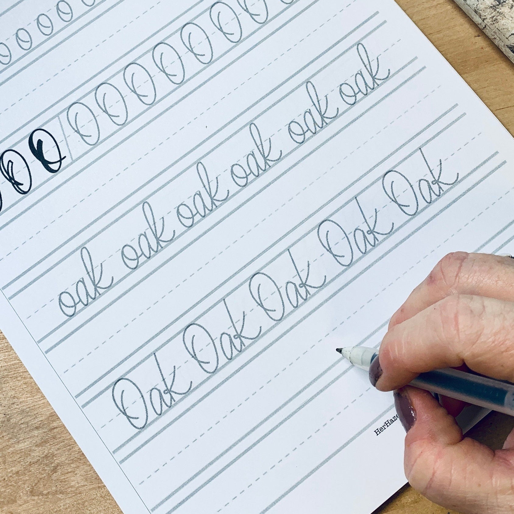 Physical handwriting practice book with traceable words and worksheets