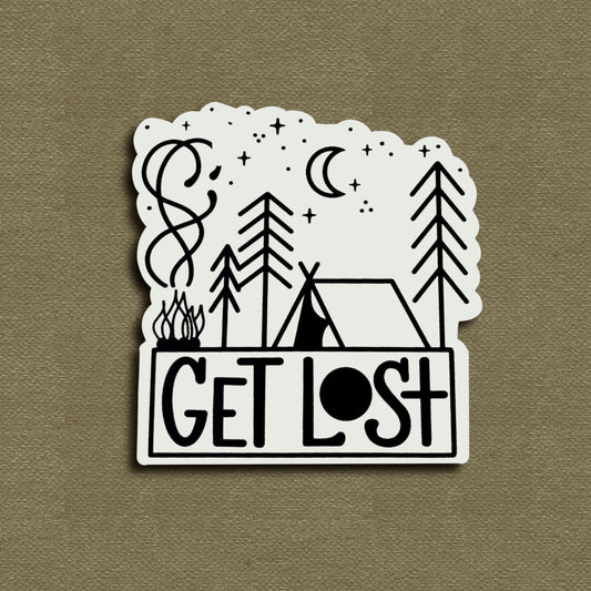 A matte vinyl decal with a hand-lettered phrase 'GET LOST' accompanied by illustrations of trees, stars, a crescent moon, and a campfire.