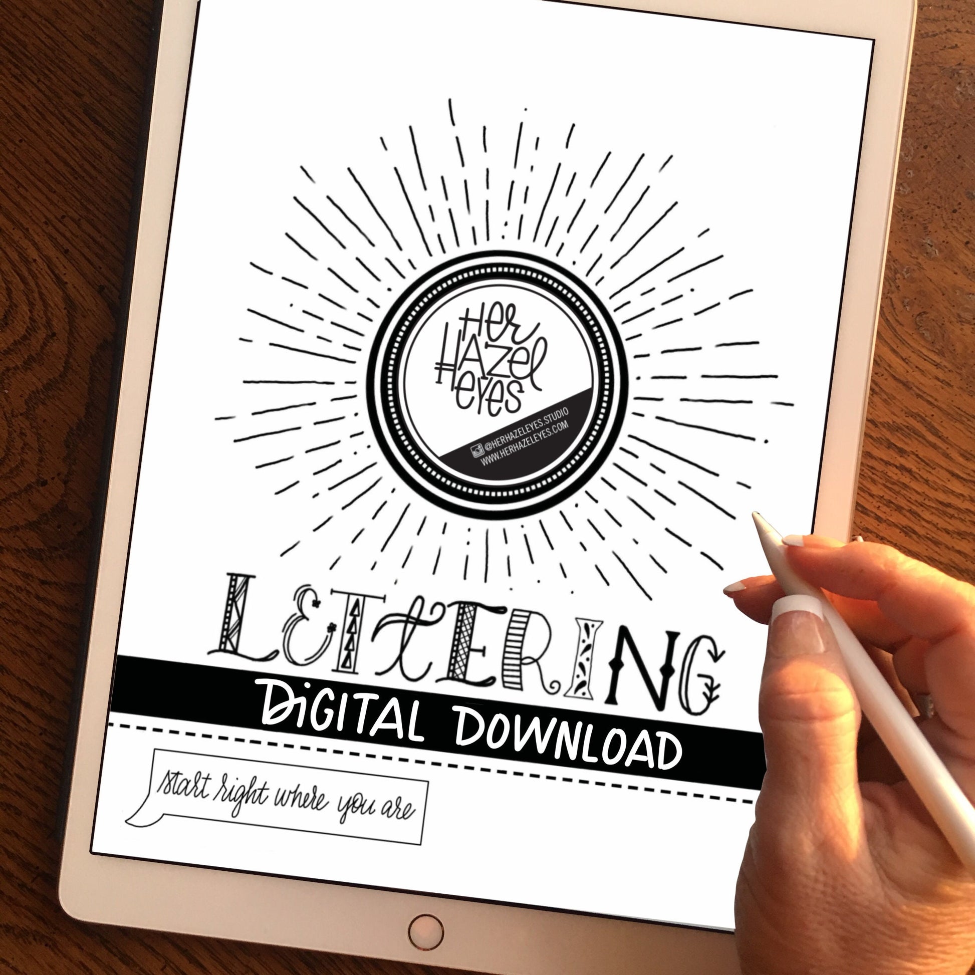 Printed hand lettering guide pages styled with pens and tracing paper for at-home practice setup