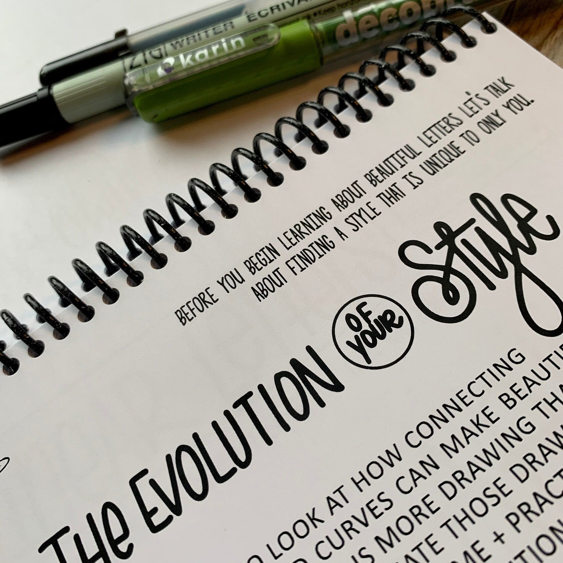 Lettering guide bundle with brush pens and monoline pen on desk