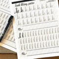 close-up of linear hand lettering worksheet showing traceable letters for guided practice