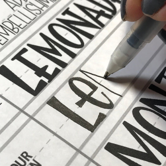 Inside page of Wonky Letters workbook showing traceable quirky block letters for lettering practice