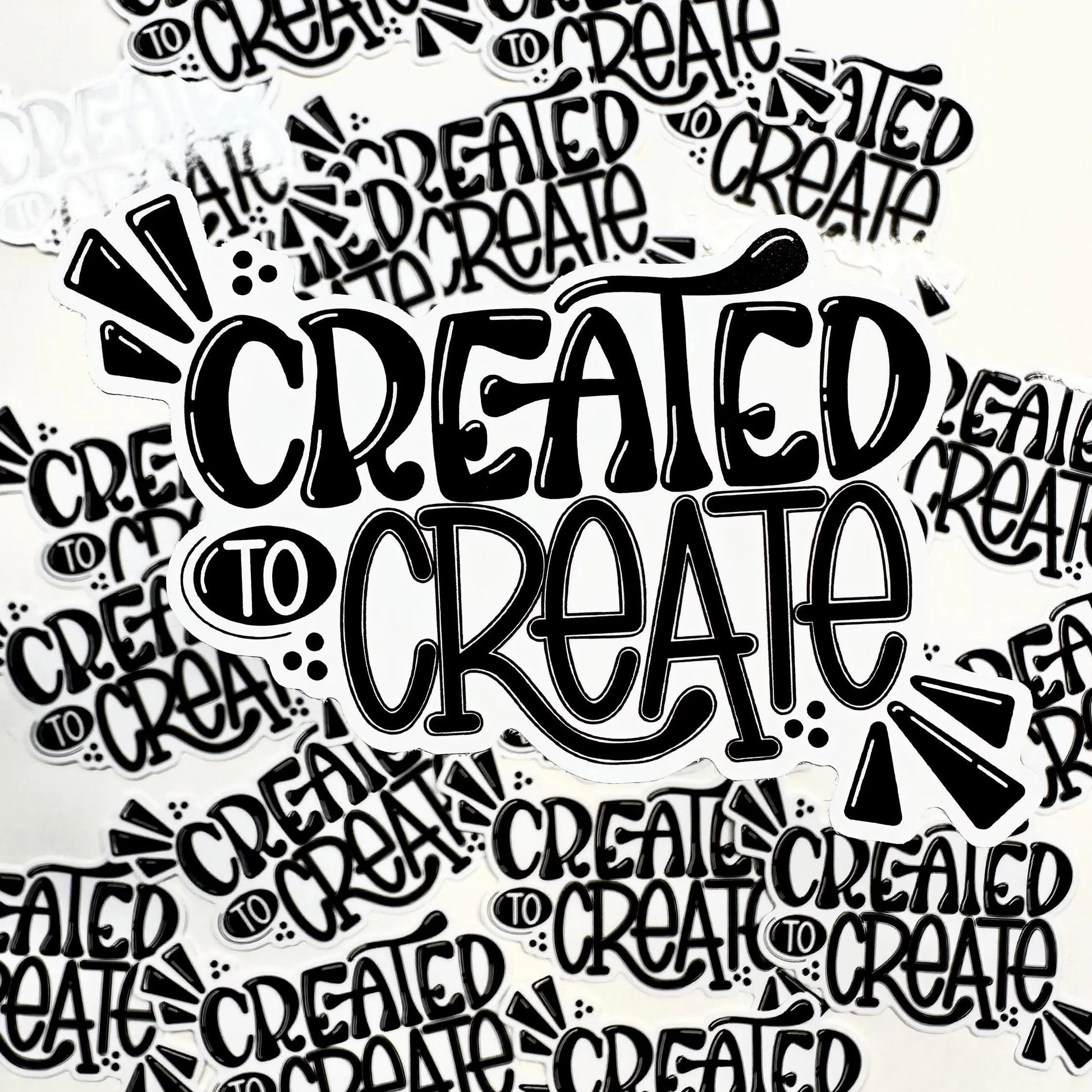 Pattern of 'CREATED TO CREATE' text in black on a white background