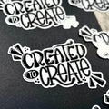 Sticker with 'Created to Create' text on a black background