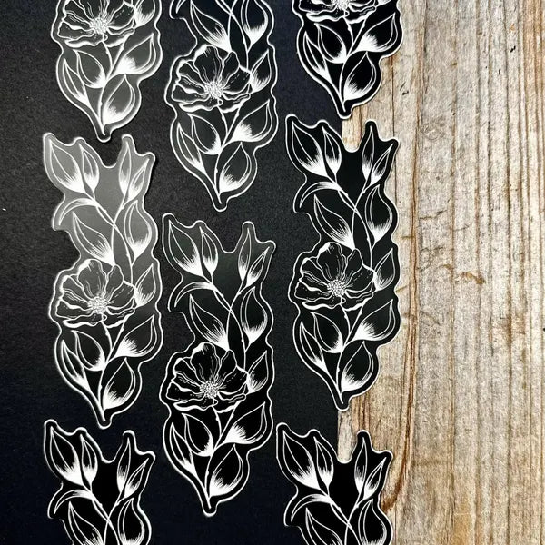 Black and white floral patterns on a textured surface