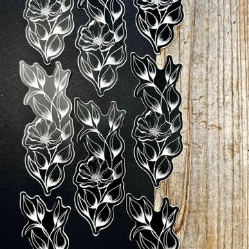 Black and white floral patterns on a textured surface