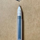 Hand writing Sakura Gelly Roll pen adding raised black ink to a journal page