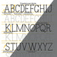 Printed Typewriter Lettering Guide worksheet shown with pen and tracing paper setup